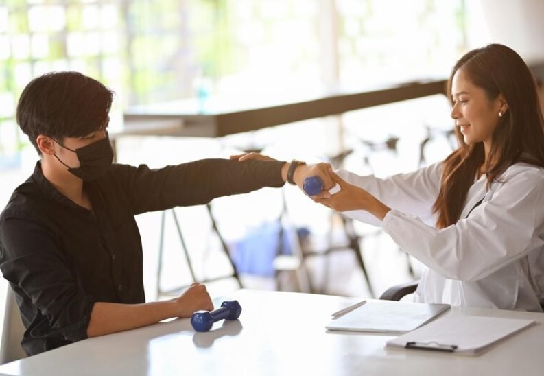 [freepicdownloader.com]-woman-with-arms-raised-standing-table-medium